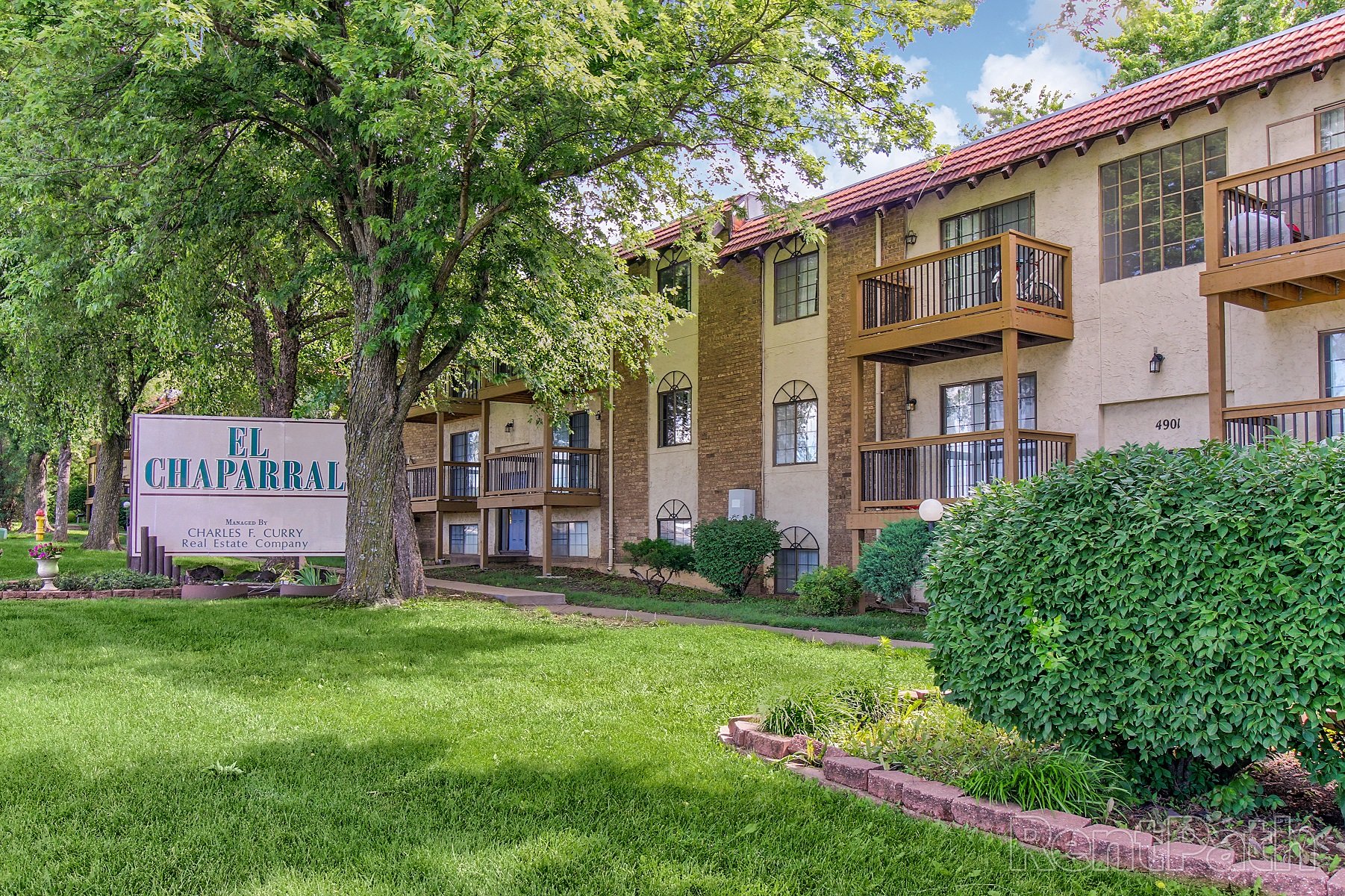 our apartments offer a green lawn and trees for residents to enjoy